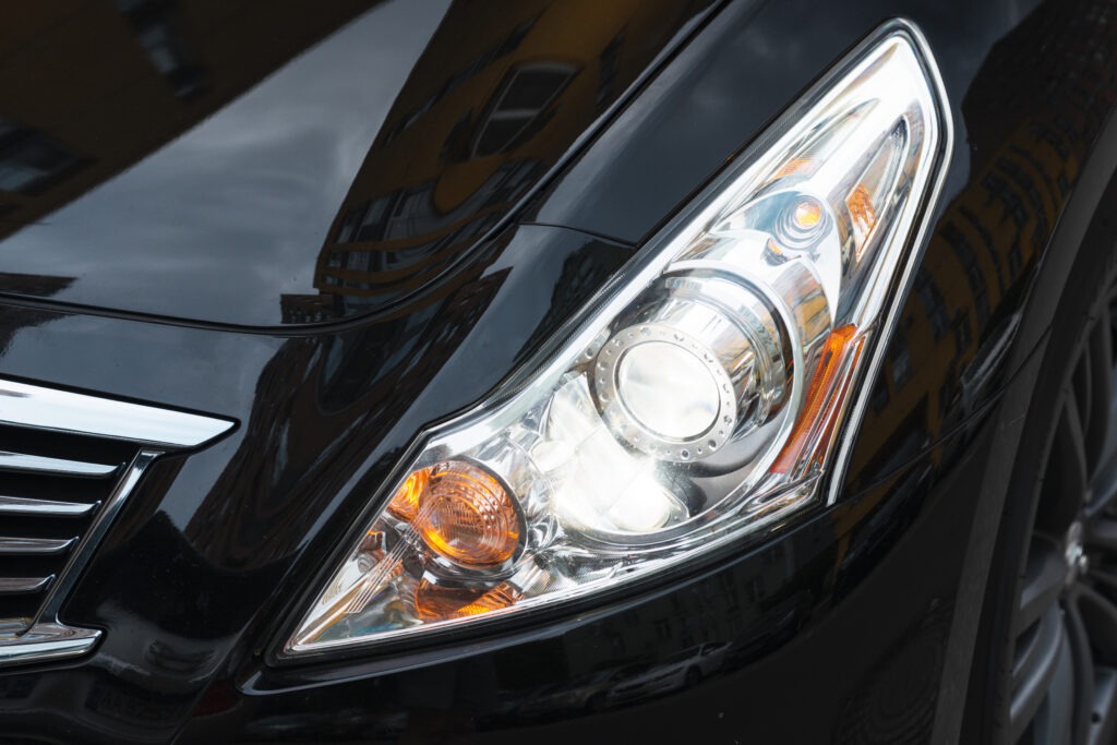Close-up of a clean and polished car headlight, reflecting pristine maintenance.