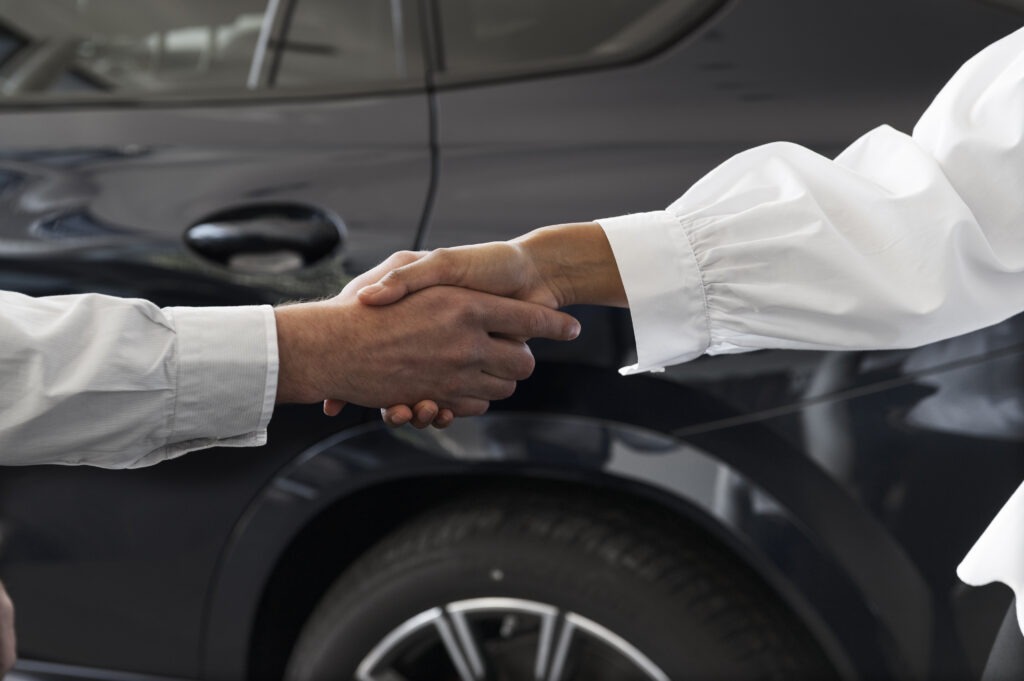 a close-up of a man and woman shaking hands